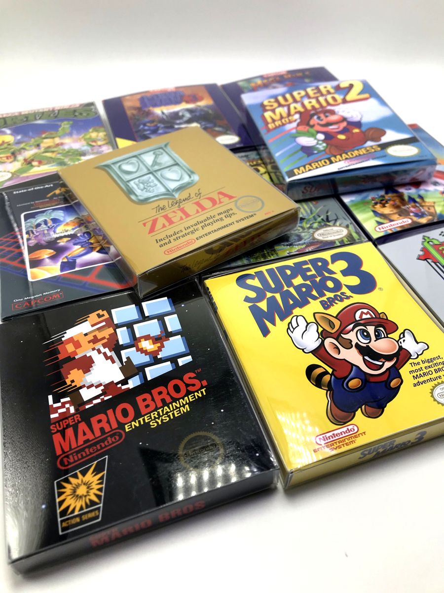 A stack of Mini Box Gaming NES cases on a shelf, smaller than a retail box and printed with the original cover art.